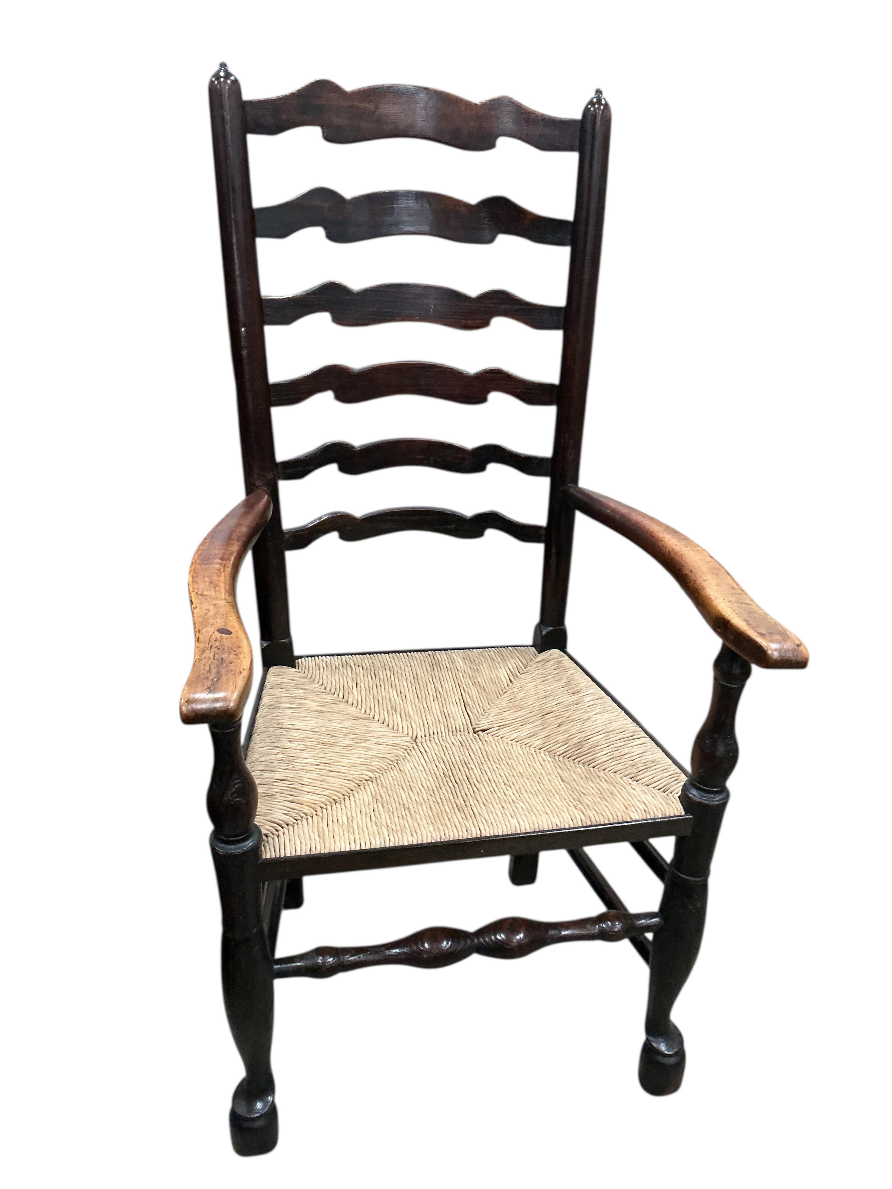 A set of eight 19th century Lancashire rush seat ash ladderback chairs, two with arms